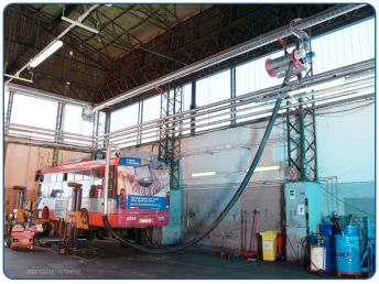 Smoke and gas extraction from a bus garage exhaust is carried out using an extraction reel connected to a central suction system.