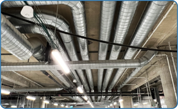 High-vacuum dust extraction piping in a galvanized structure