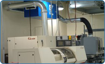 An electrostatic filter manufactured by TRION draws air from a machining center and filters the air from the emulsion